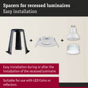 Black plastic spacer and white recessed mounting frames with LED light for ceiling luminaires