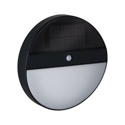 Round black solar wall light with motion sensor and white diffuser for outdoor lighting