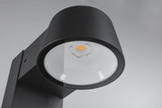 Black metal LED outdoor wall light with round glass and warm white light for garden lighting