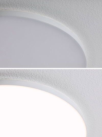 Close-up of round white LED ceiling light with fine edge and textured ceiling surface