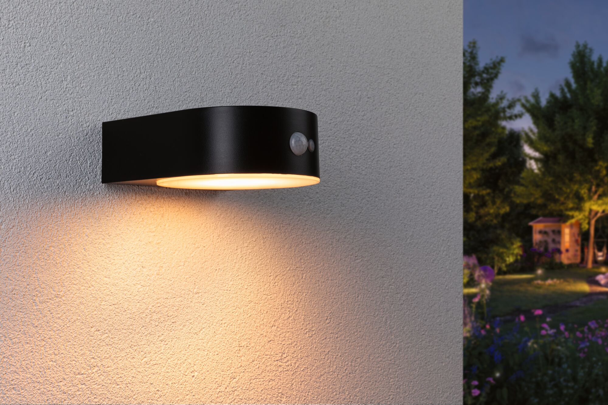 Black metal outdoor wall light with motion sensor and warm white light for garden illumination