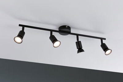 Black ceiling light with four adjustable metal spotlights for modern room lighting.