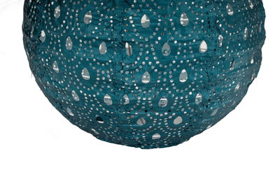 Round blue paper lampshade with perforated pattern for decorative lighting in living spaces