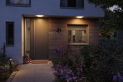 Modern house entrance with wooden cladding and warm white LED ceiling lights for outdoor lighting.