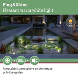Warm white LED garden lights create atmospheric lighting on terrace and pond area