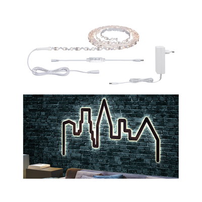 White LED strip light with controller and power supply, illuminating skyline wall decoration in modern living room.