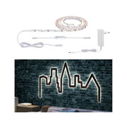 White LED strip light with controller and power supply, illuminating skyline wall decoration in modern living room.