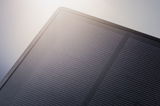 Close-up of a black solar panel with fine lines on the surface for sustainable energy use.