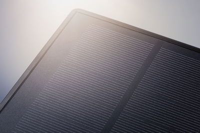 Close-up of a black solar panel with fine lines on the surface for sustainable energy use.