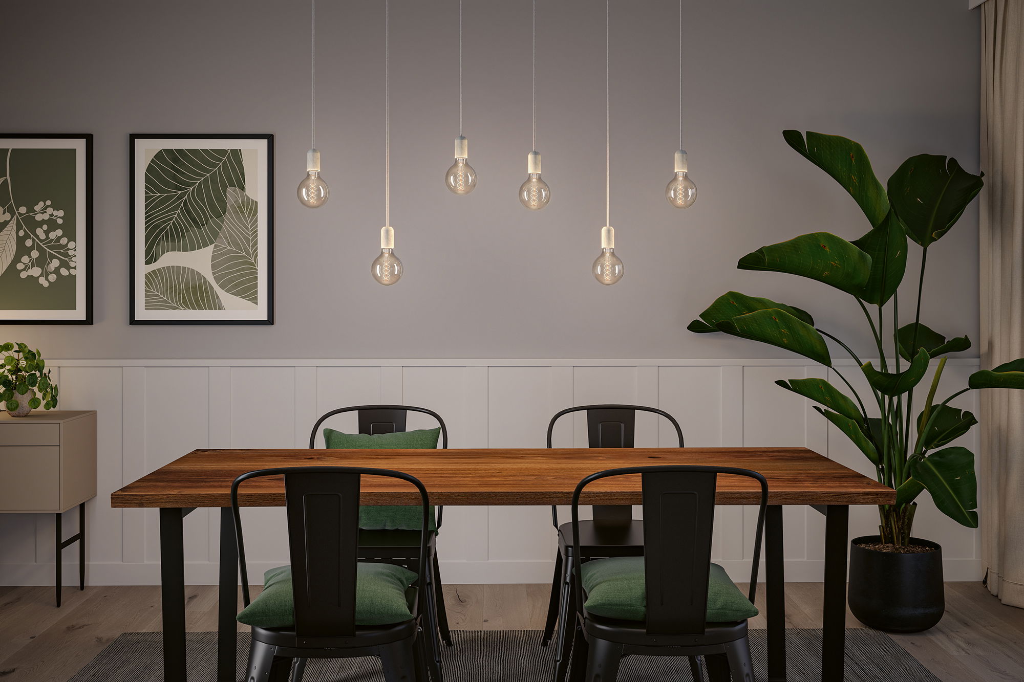 Modern dining area with wooden table, black metal chairs and seven hanging LED light bulbs.