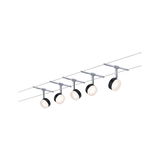 Five black LED cable spotlights with adjustable heads on silver wire system for modern room lighting