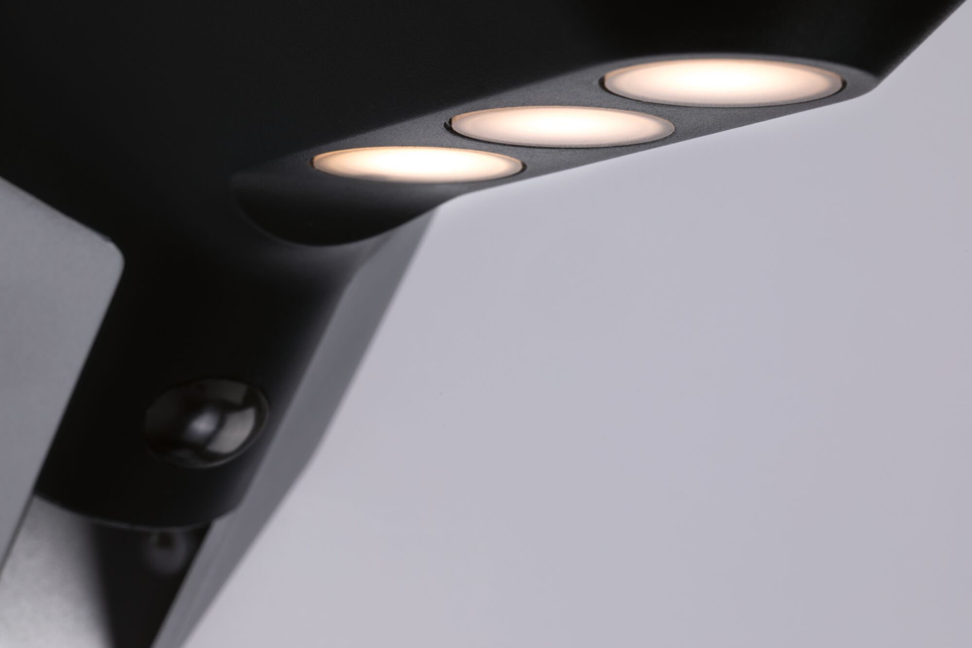 Black LED outdoor light with three warm white lamps and motion sensor for garden lighting