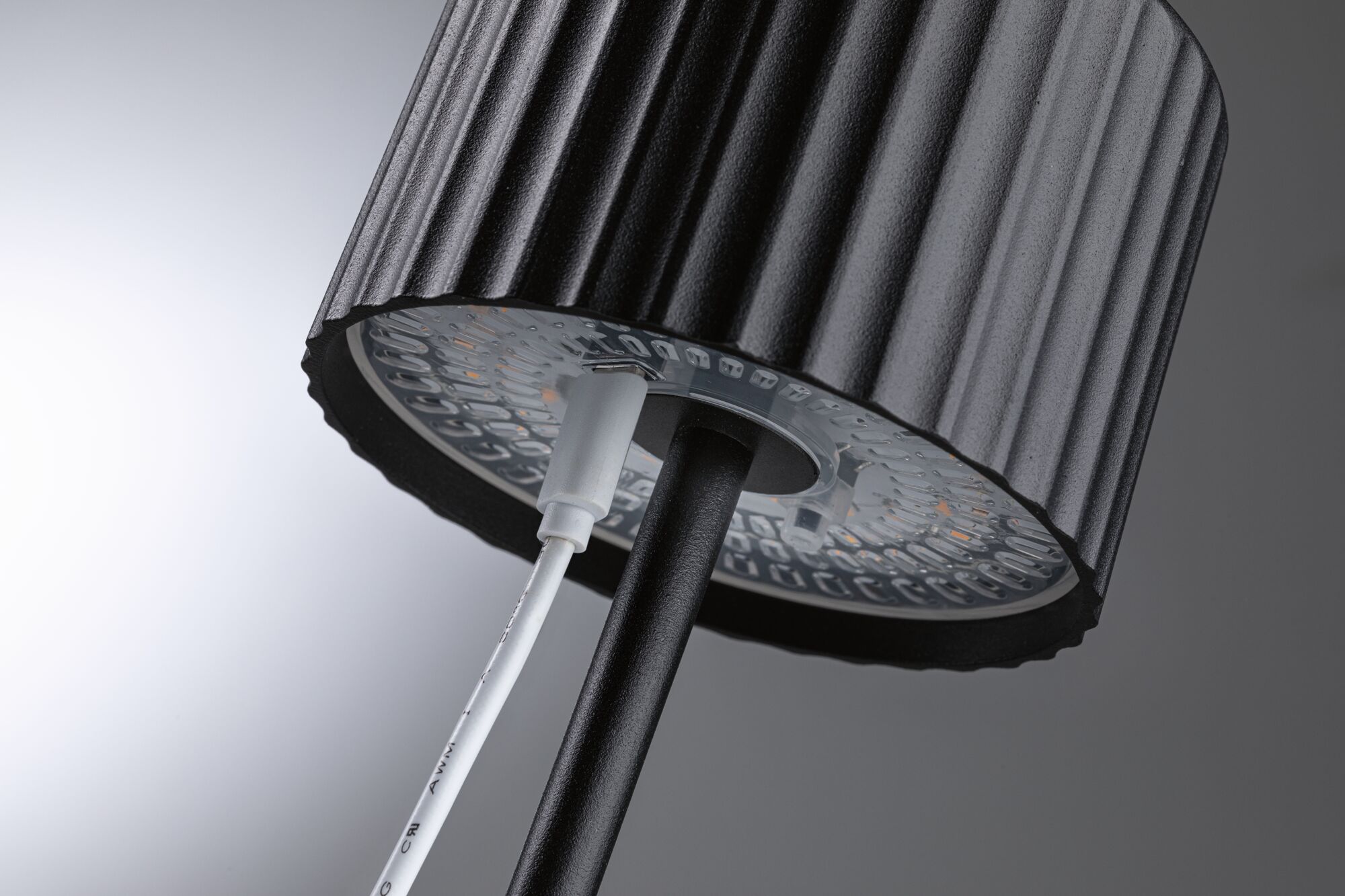 Black LED floor lamp shade with ribbed texture and visible cable connection for modern lighting design