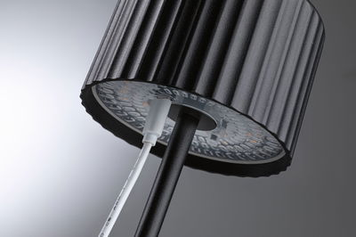 Black LED floor lamp shade with ribbed texture and visible cable connection for modern lighting design