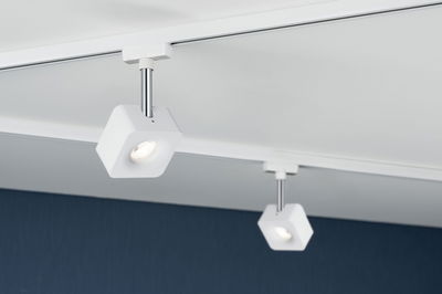 White square LED track spotlights with metal rod on white ceiling for modern room lighting