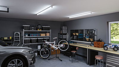 Garage moderne avec voiture grise, atelier vélo et éclairage LED au plafond pour un espace de travail lumineux