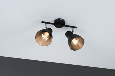 Black ceiling light with two adjustable metal spotlights and warm white light for living spaces.