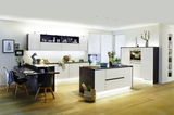 Modern kitchen with white-black fronts and warm white LED under-cabinet lighting for ambient illumination
