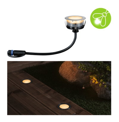 Round LED recessed light with black cable and warm white glow for garden and terrace lighting