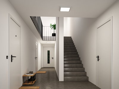 Modern stairwell with grey floor, white doors and square plastic ceiling light for indoor lighting