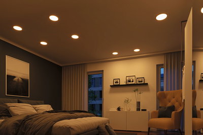 Modern bedroom with warm white LED recessed lights in ceiling providing cozy ambient lighting