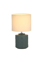 Table lamp with green ceramic base and cream fabric shade for cozy ambient lighting