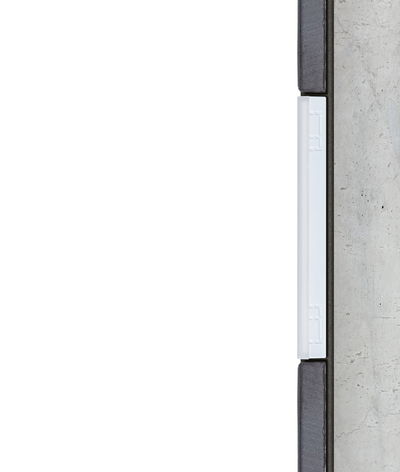 Cross-section of white LED light strip in modern wall installation with concrete and wood.