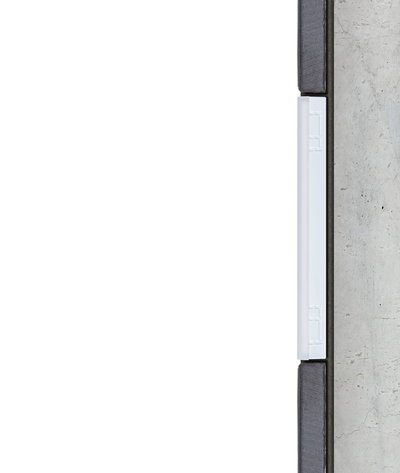 Cross-section of white LED light strip in modern wall installation with concrete and wood.