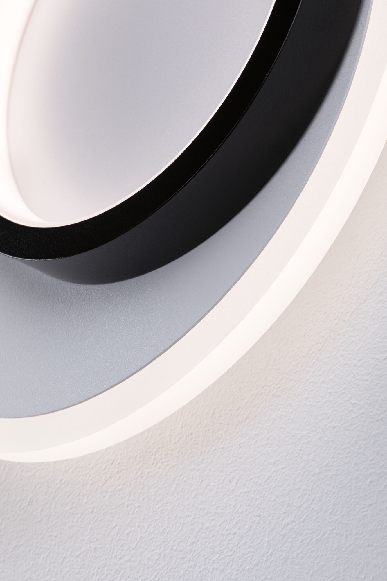 Modern round LED ceiling light with black metal frame and white diffuser for living spaces