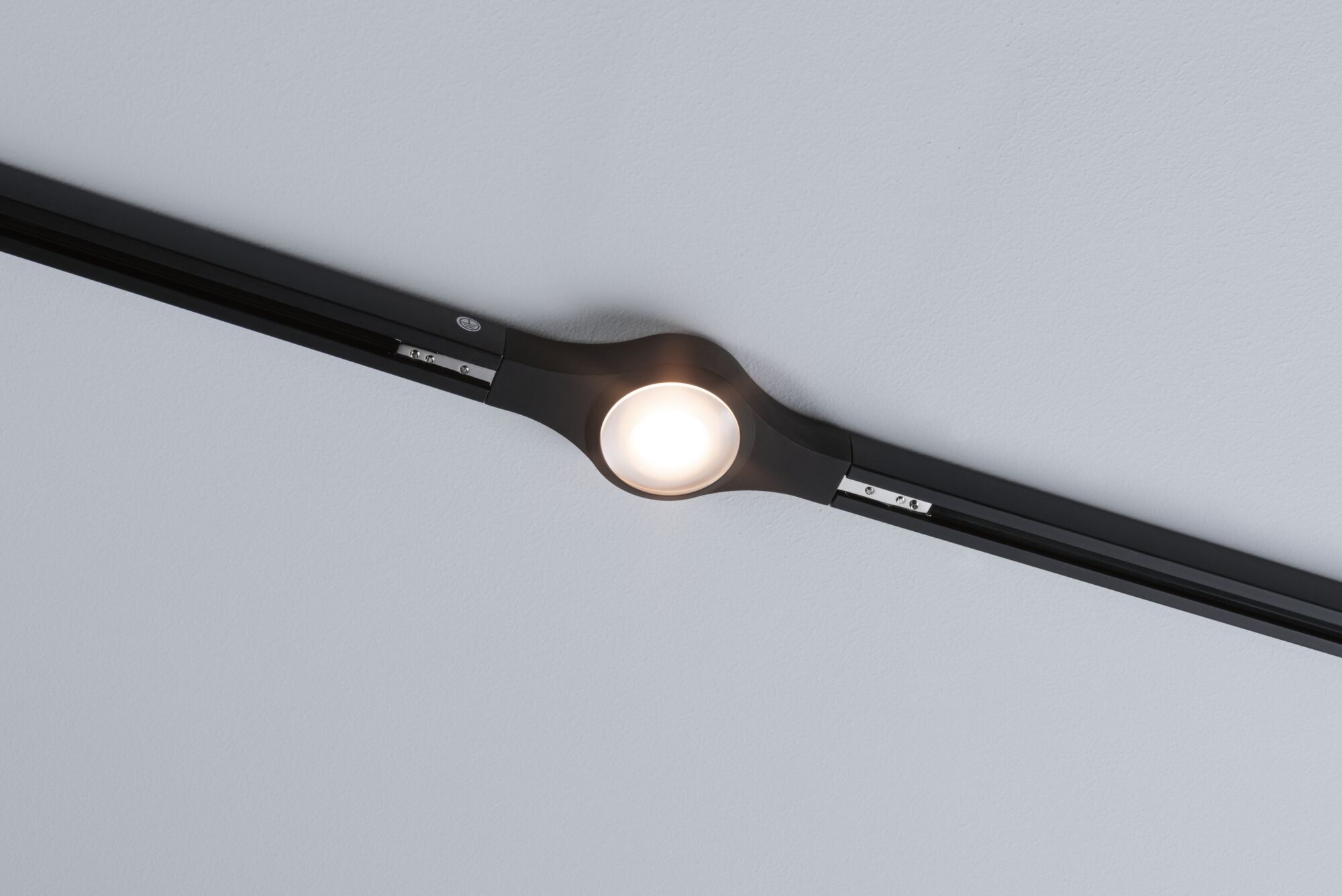 Zwarte LED-plafondlamp met ronde lamp en smal railsysteem voor moderne binnenverlichting