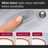 Finger adjusts light colour on ceiling lamp with wooden edge to warm white, neutral white or daylight