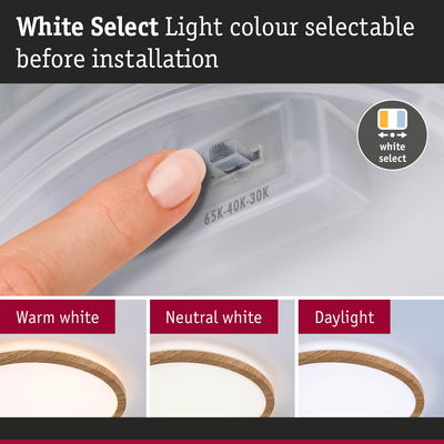 Finger adjusts light colour on ceiling lamp with wooden edge to warm white, neutral white or daylight