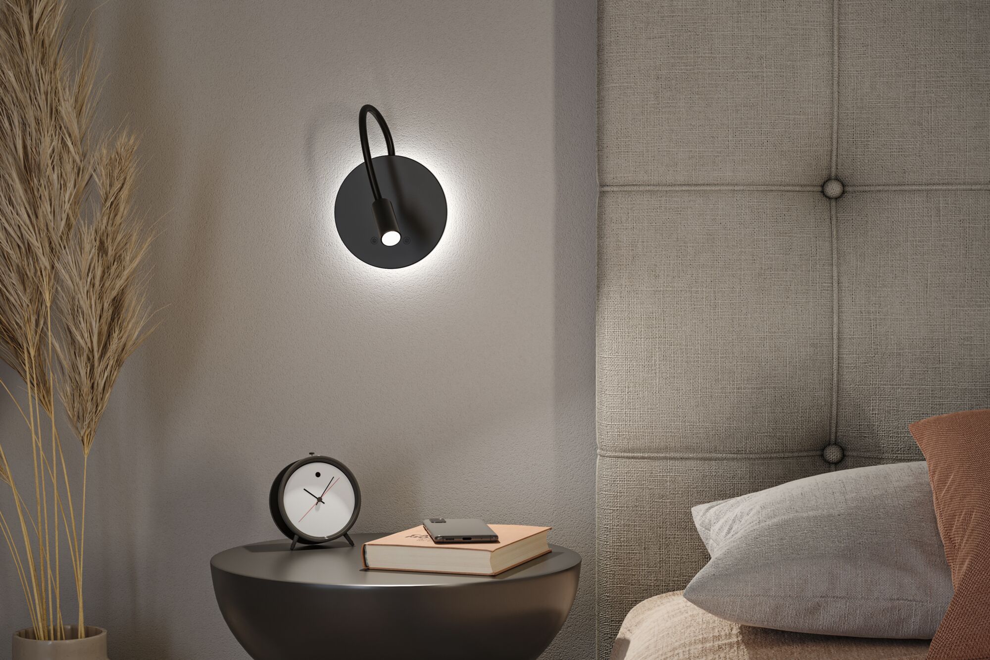 Black LED wall light with flexible arm on grey wall beside bed and nightstand with clock and book