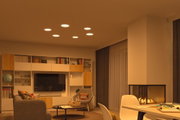 Living room with modern ceiling lights, fireplace, and wood-gray furniture creating a cozy ambiance