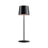 Black metal floor lamp with round base and cylindrical shade ideal for modern living spaces