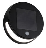 Round black solar light with motion sensor and integrated LED for outdoor use