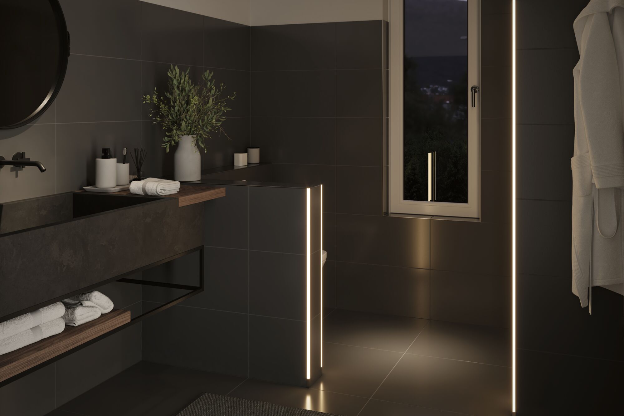 Modern bathroom with black tiles and warm white LED light strips creating ambient lighting effect