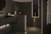 Moderne badeværelse med sorte fliser og varm hvide LED-lysstriber til stemningsfuld belysning
