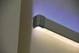 Modern grey aluminium LED wall light with warm white and blue lighting for stylish home interiors