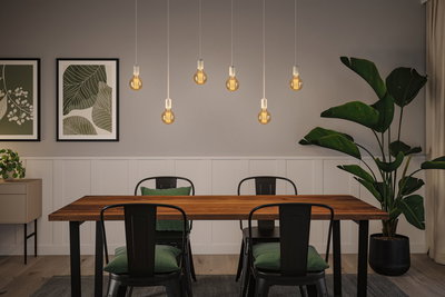Modern dining area with wooden table, black metal chairs, and warm LED pendant lights for home lighting.