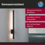 Schwarze LED-Wandleuchte mit seewasserresistenter Oberfläche an weißer Wand mit Meerblick