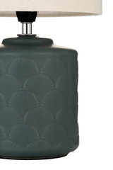 Table lamp with dark green ceramic base and shell pattern, cream fabric shade for home lighting