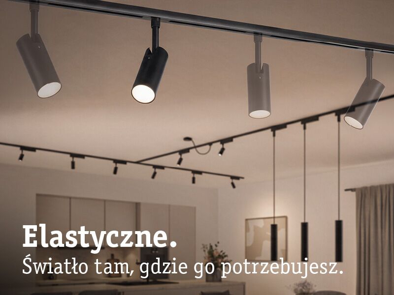 Czarne i białe elastyczne reflektory LED na szynie sufitowej w nowoczesnym wnętrzu z regulowanym światłem