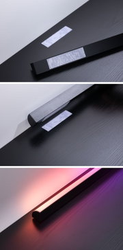 Schwarze LED-Lichtleiste mit Klettverschluss auf dunklem Holz, dimmbares RGB-Stimmungslicht.