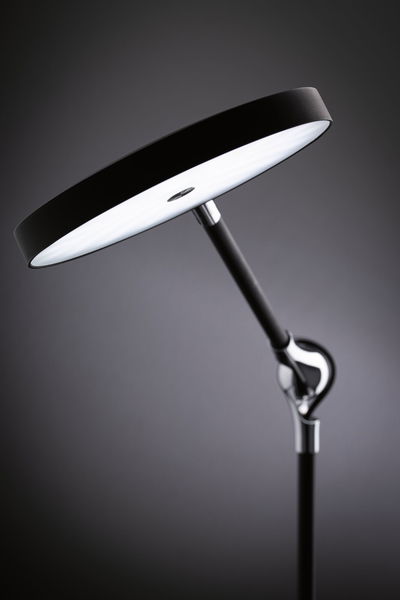 Modern black LED floor lamp with round light head and adjustable metal arm for living spaces
