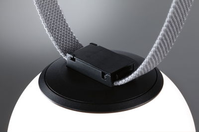 Close-up of black plastic clasp with grey fabric strap on LED lighting fixture for modern interiors