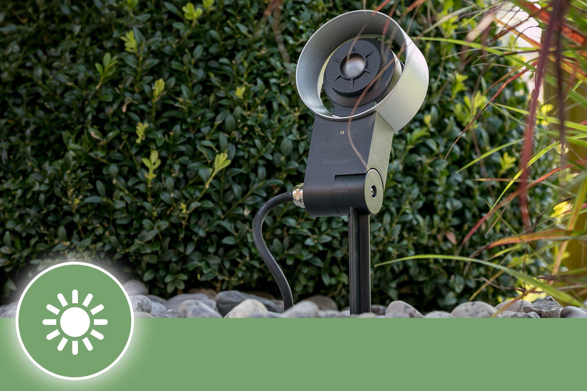 Black metal outdoor spotlight with silver reflector and ground spike for garden lighting