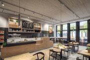 Modernes Café mit Holztheke, schwarzen Fliesen und minimalistischer LED-Deckenbeleuchtung für Gastronomie