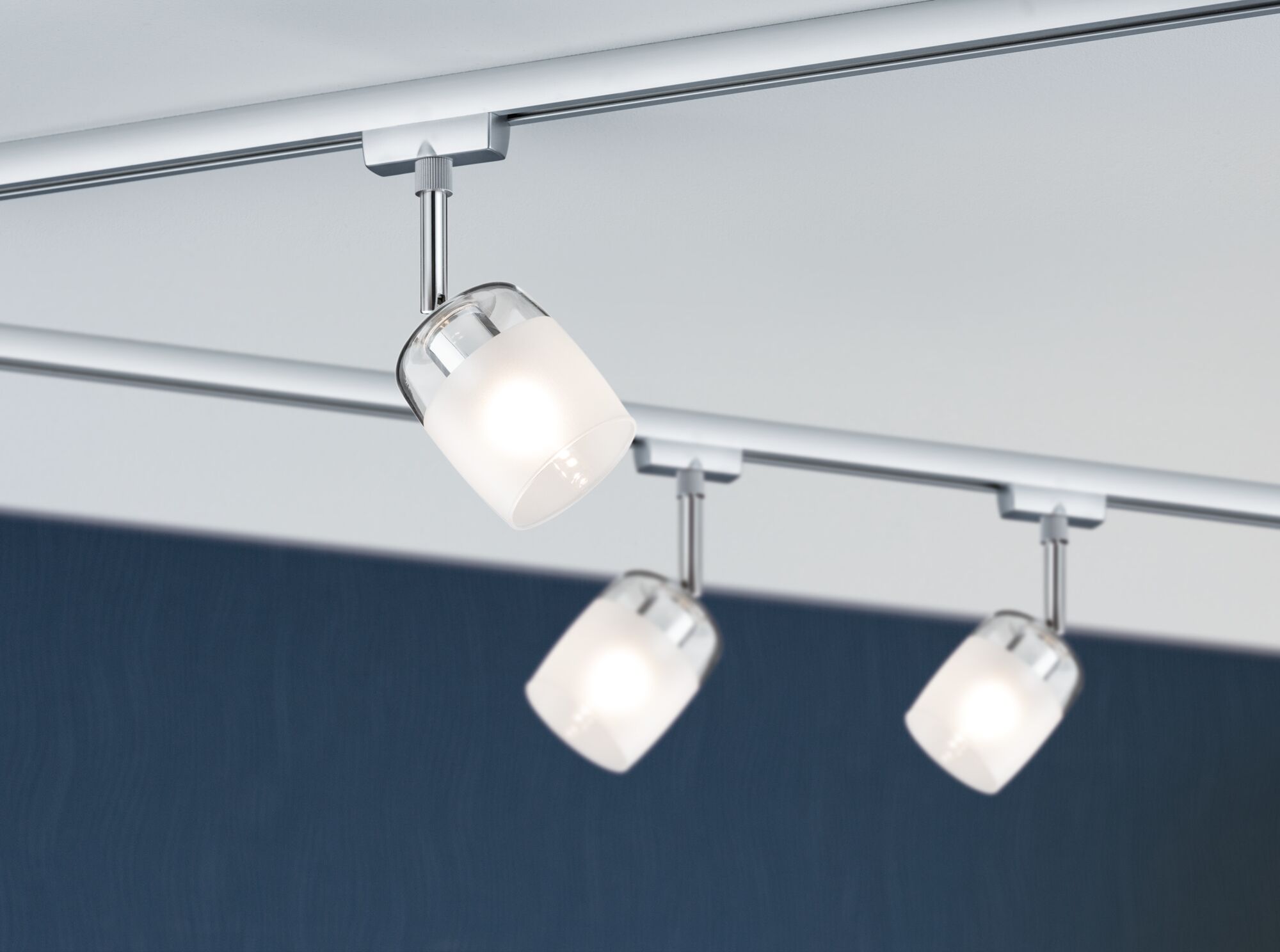 Three modern ceiling spotlights with frosted white glass and chrome mounts for stylish room lighting