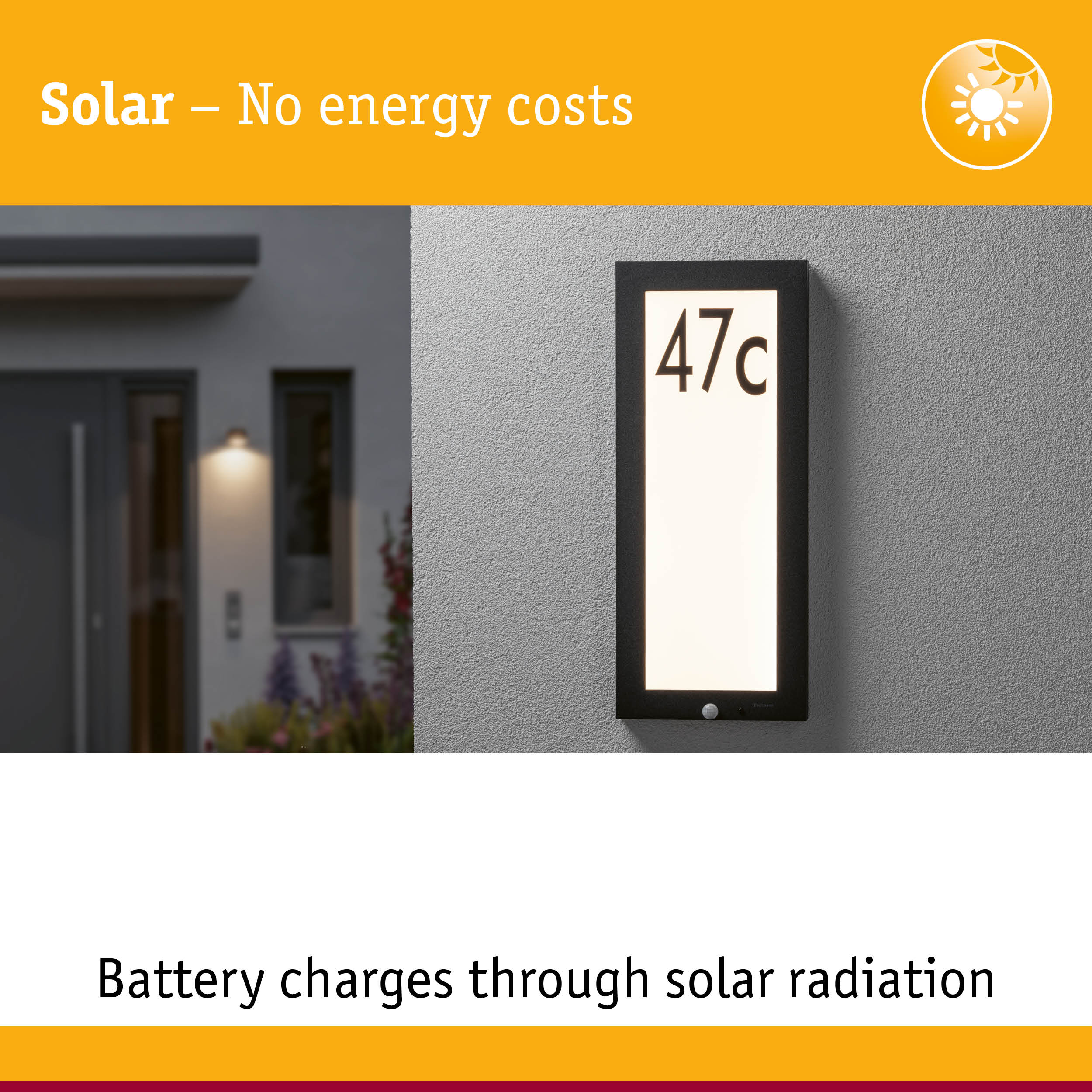 Black solar house number sign with white LED light on grey wall for energy-saving outdoor lighting